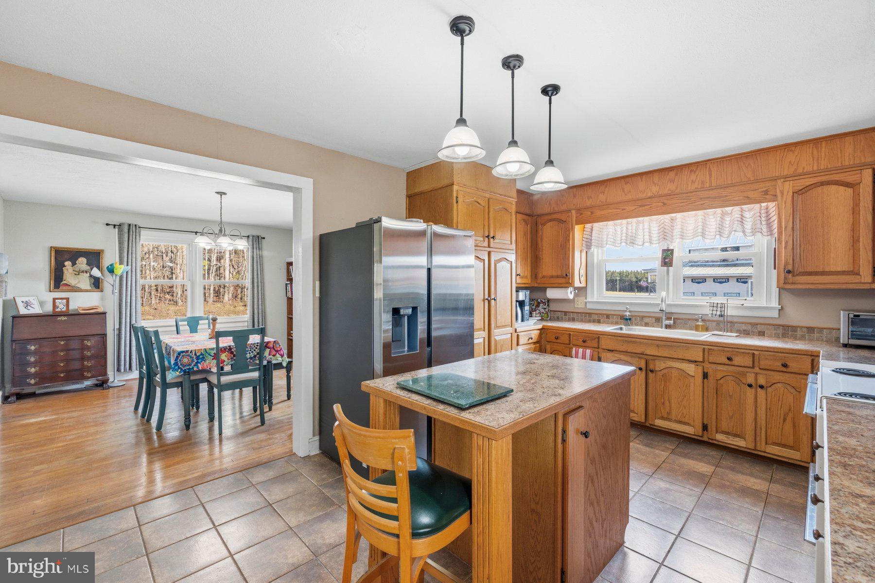 2092 Rocksprings Road Ringgold, VA 24586 - Photo 25 of 86 a kitchen with stainless steel appliances granite countertop table chairs and a refrigerator