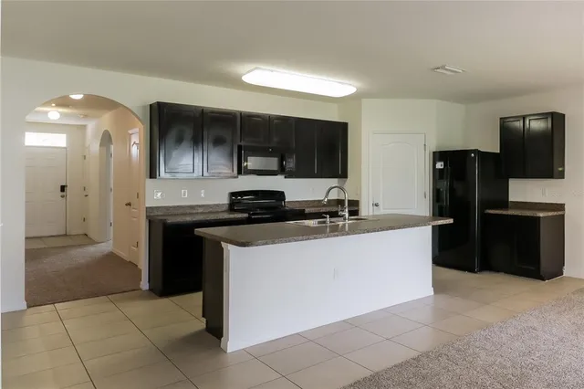 a kitchen with stainless steel appliances a sink stove and refrigerator