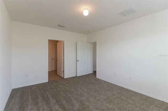 a view of an empty room and a window