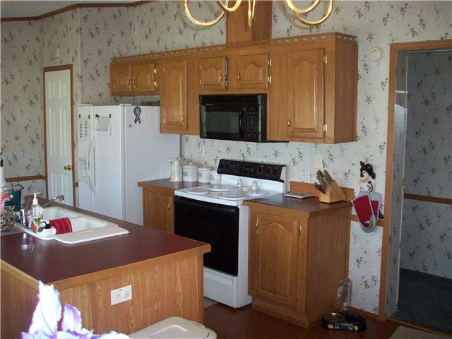 6200 Underwood Road Springfield, TN 37172 - Photo 9 of 16 a kitchen with a sink refrigerator and cabinets