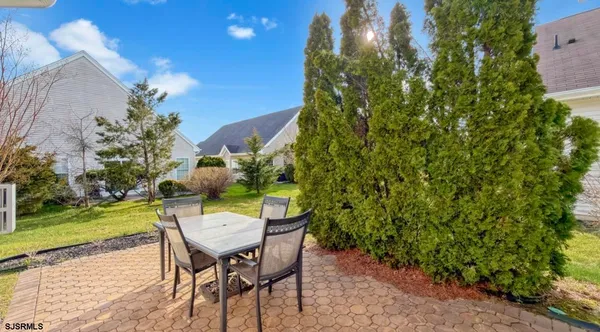 a view of a chairs and table in backyard