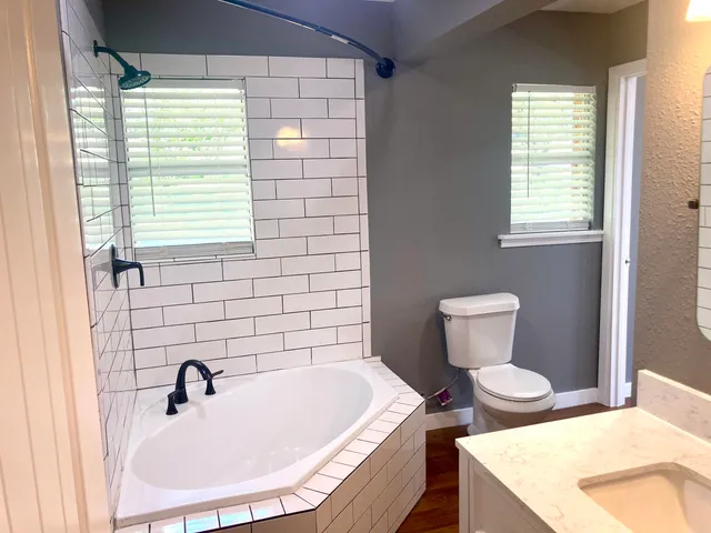 a bathroom with a sink a toilet and tub