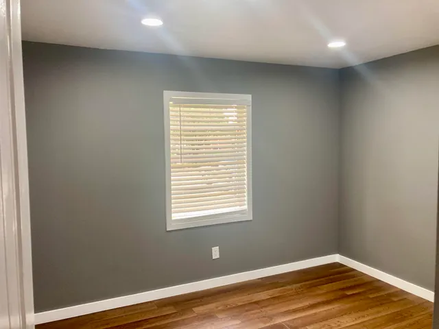a view of a room with wooden floor and windows