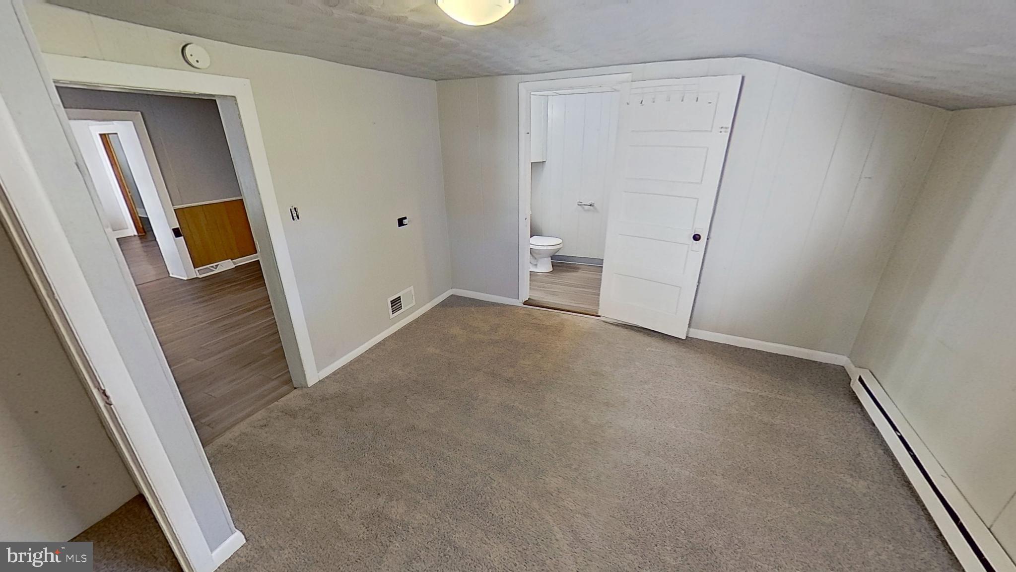 648 Broadway, Unit B Hanover, PA 17331 - Photo 4 of 12 an empty room with mirror