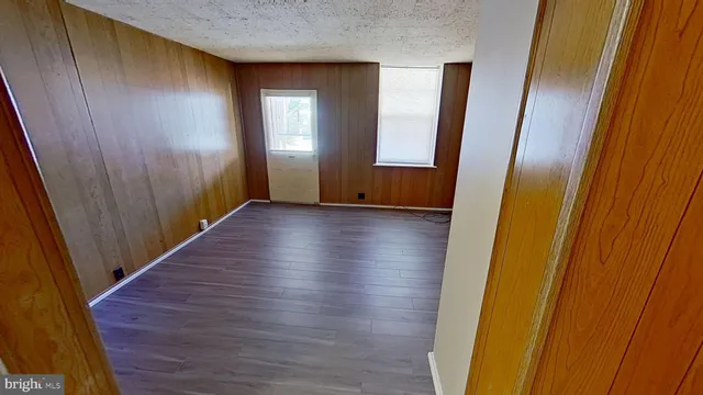 a view of hallway with stairs and wooden floor
