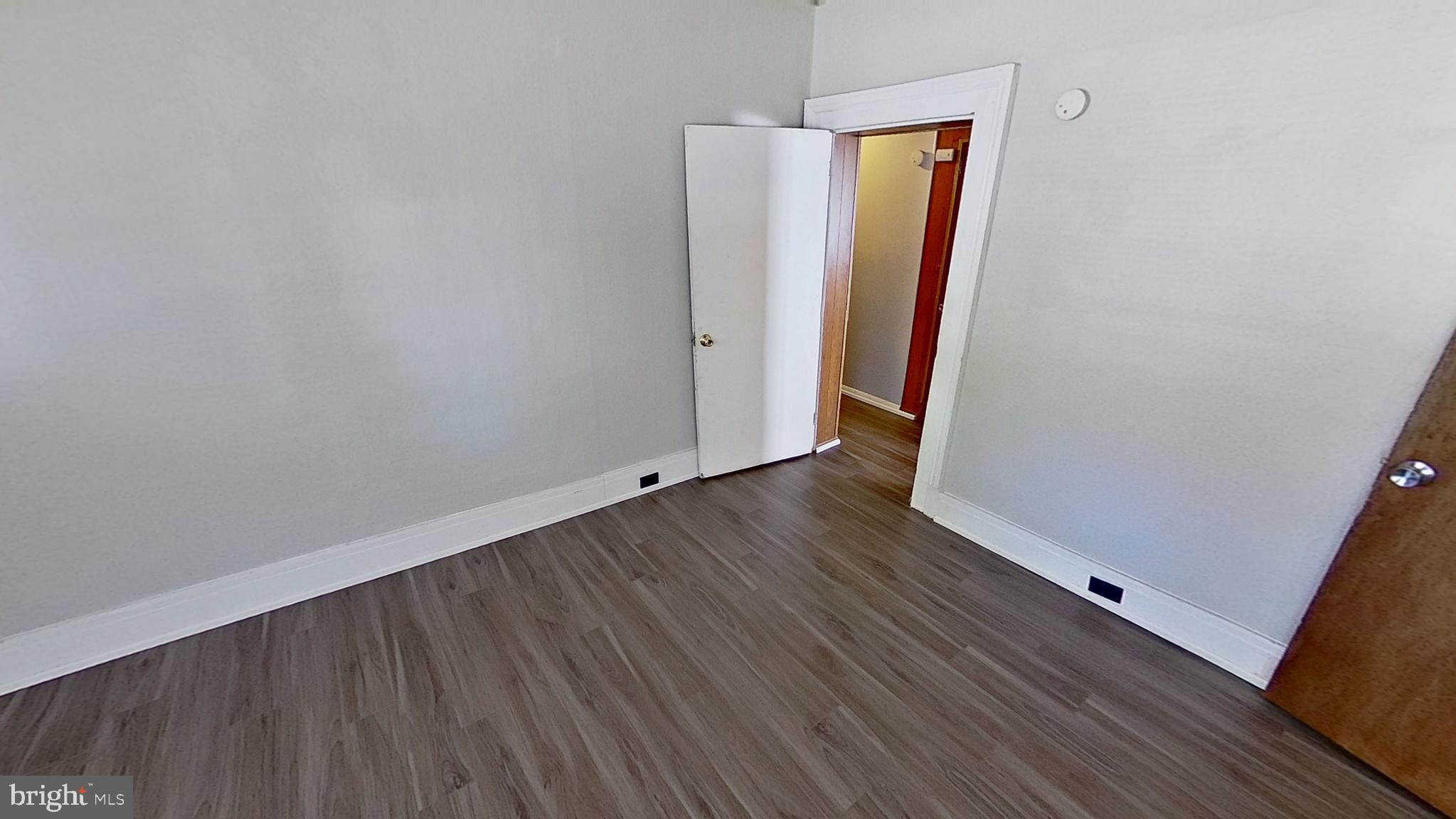 648 Broadway, Unit B Hanover, PA 17331 - Photo 7 of 12 an empty room with wooden floor and a window