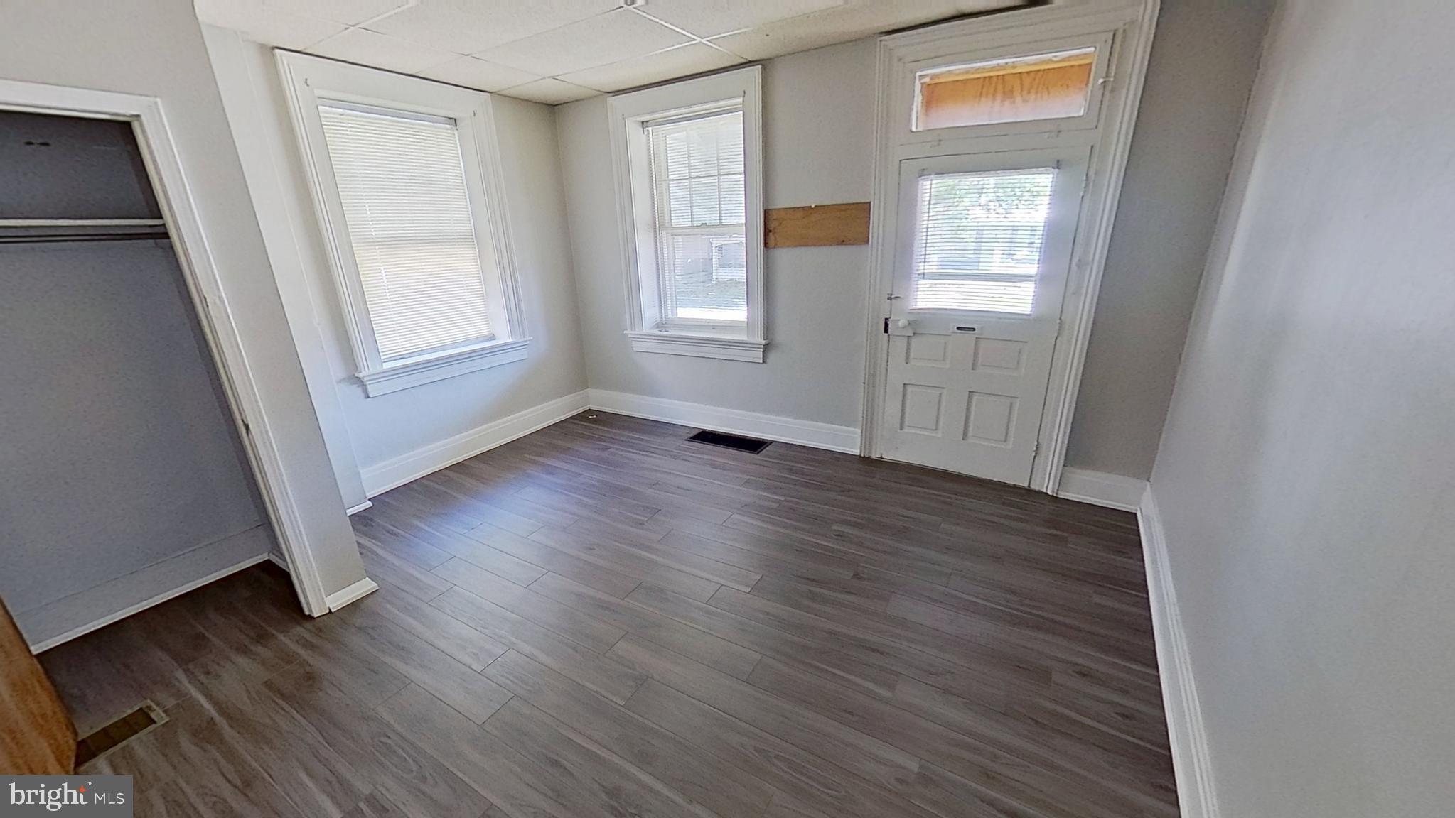 648 Broadway, Unit B Hanover, PA 17331 - Photo 8 of 12 an empty room with wooden floor and windows