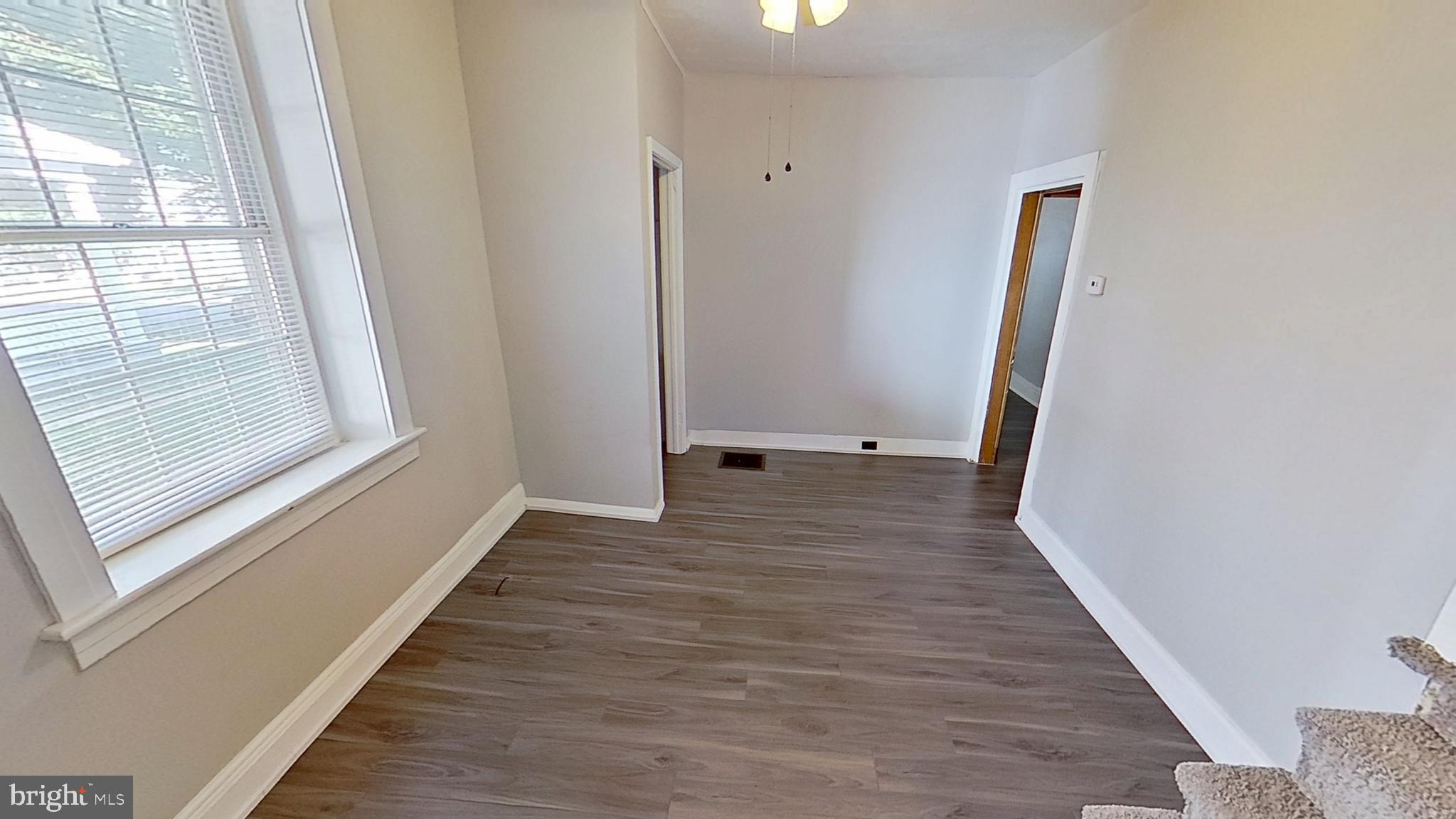 648 Broadway, Unit B Hanover, PA 17331 - Photo 10 of 12 a view of a hallway with wooden floor and staircase