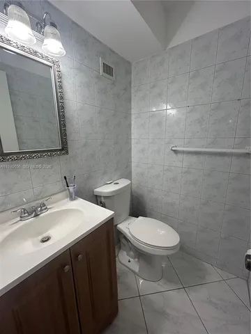 a kitchen with a sink a refrigerator and cabinets