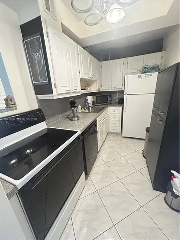 a kitchen with a sink a stove and a refrigerator
