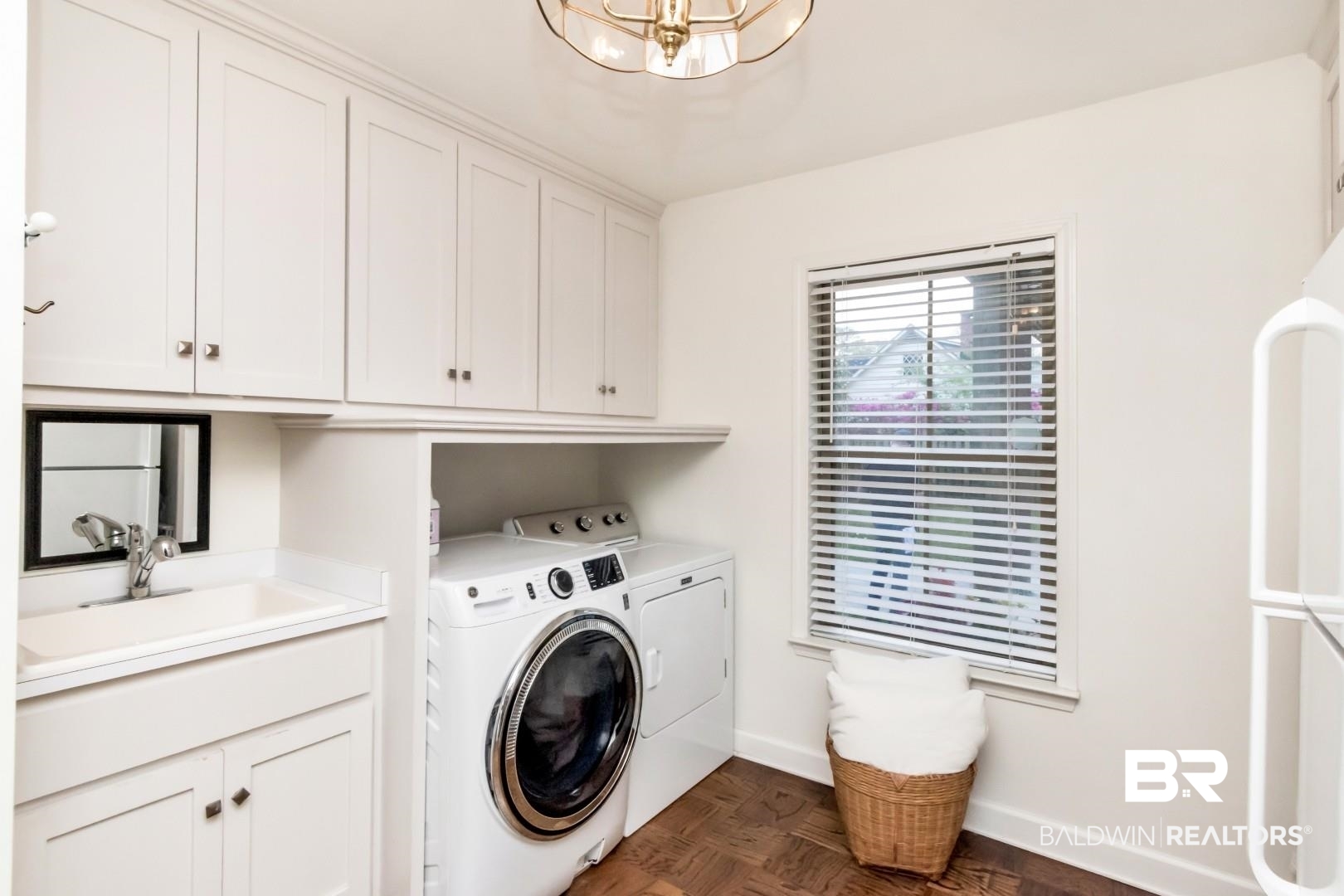 154 Fenwick Road Mobile, AL 36608 - Photo 29 of 48 Laundry room with parquet flooring, independent washer and dryer, cabinet space, and a chandelier
