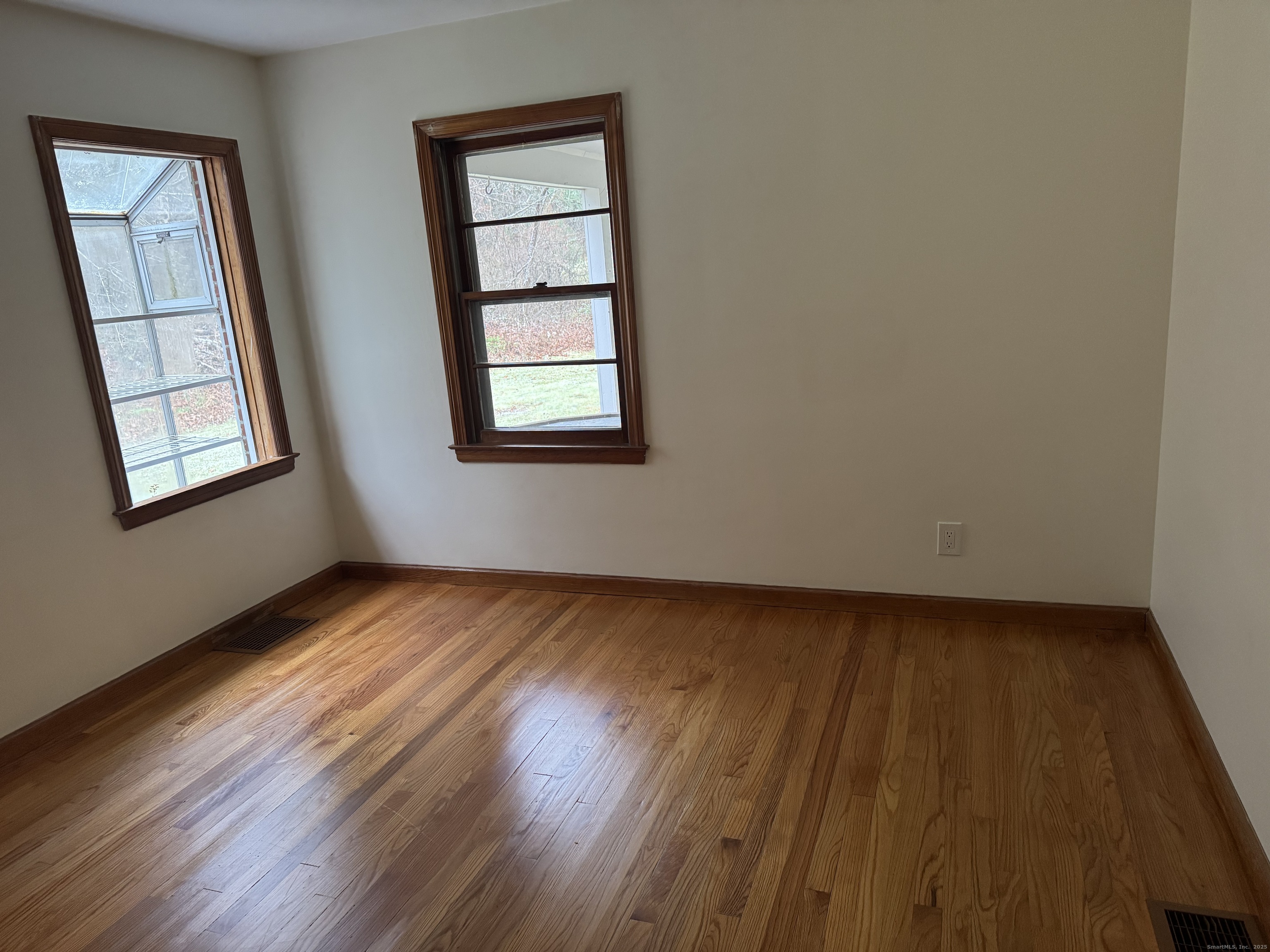 85 Mountain Road Norfolk, CT 06058 - Photo 14 of 15 a view of an empty room with wooden floor and a window