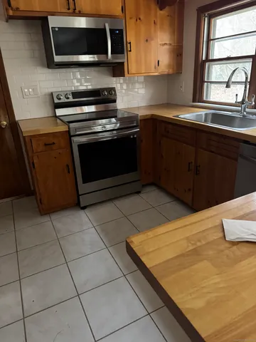 a kitchen with a sink and a stove top oven
