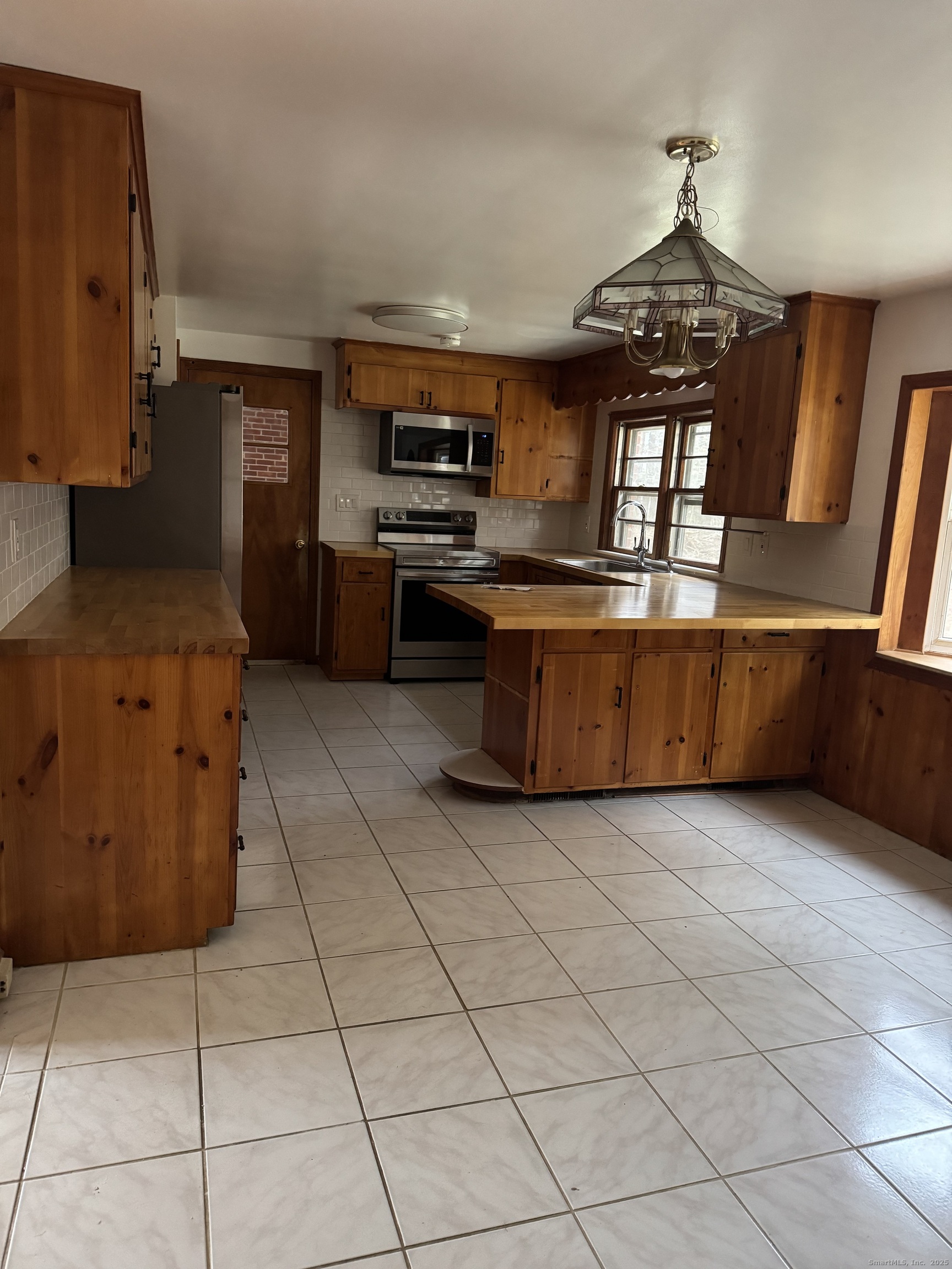 85 Mountain Road Norfolk, CT 06058 - Photo 5 of 15 a kitchen with stainless steel appliances granite countertop a stove a sink and a refrigerator