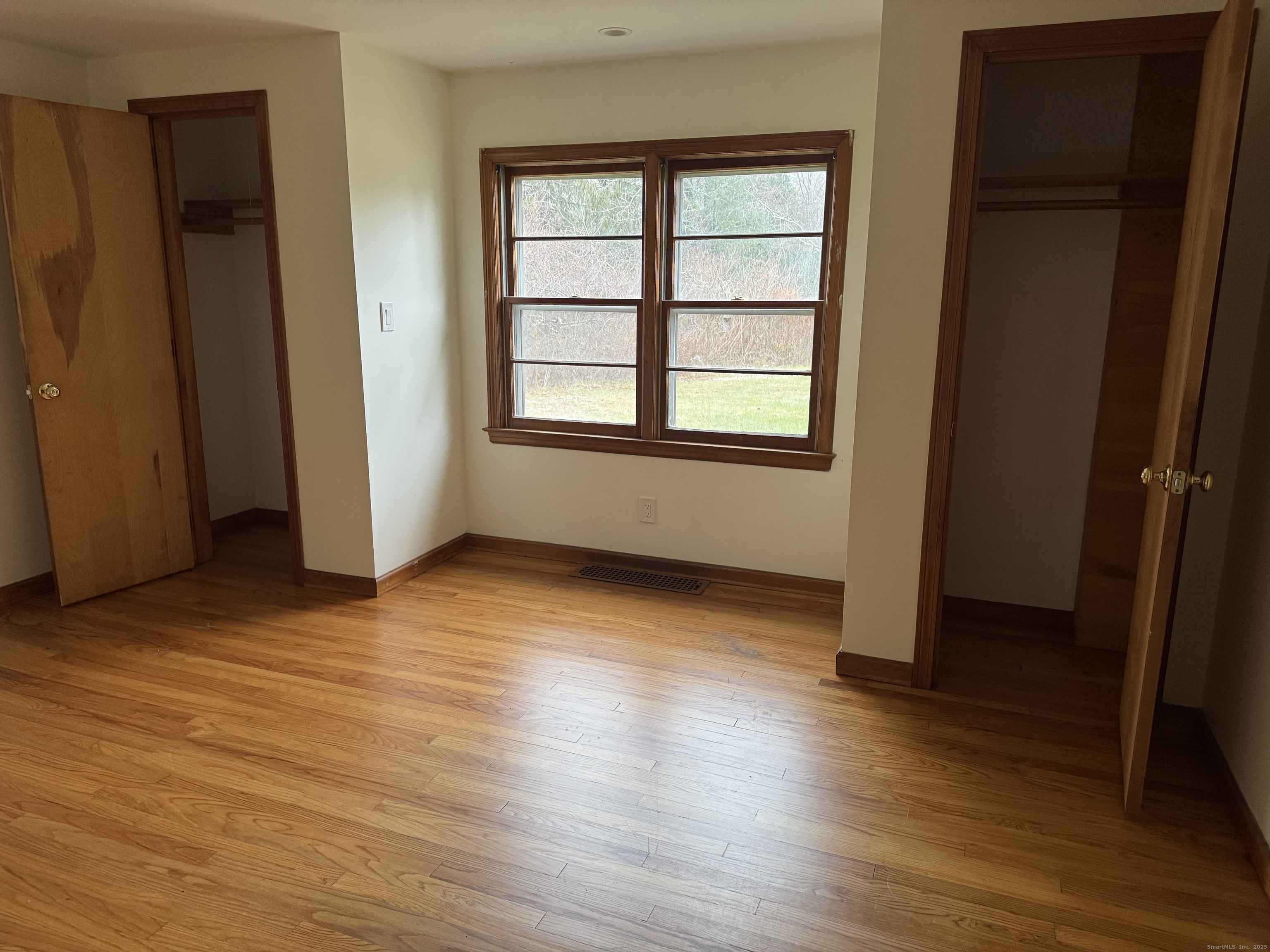 85 Mountain Road Norfolk, CT 06058 - Photo 8 of 15 an empty room with wooden floor and windows
