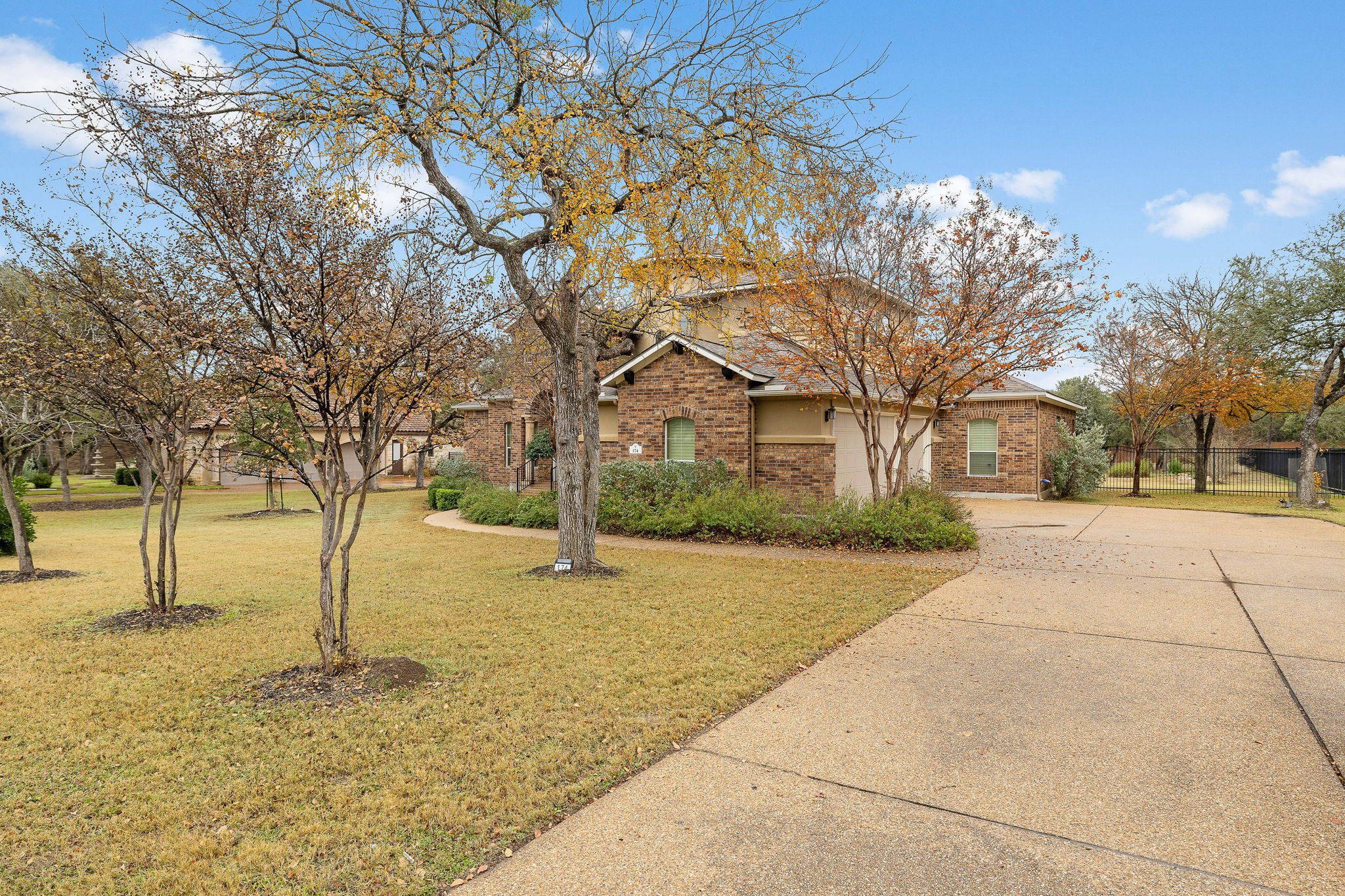 174 Estrella Crossing Georgetown, TX 78628 - Photo 36 of 38 View of front of property with concrete driveway, a front yard, and brick siding