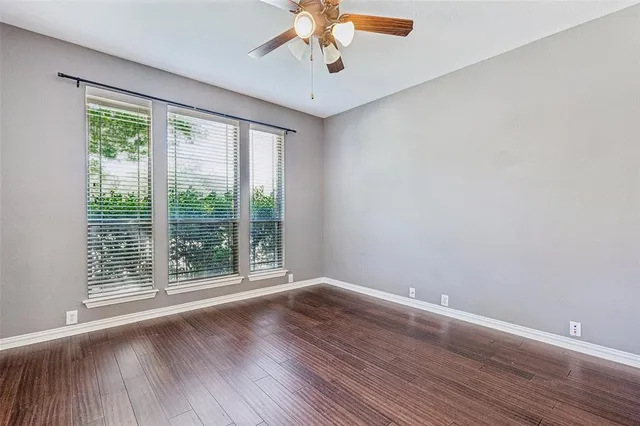 a view of wooden floor and windows in a room