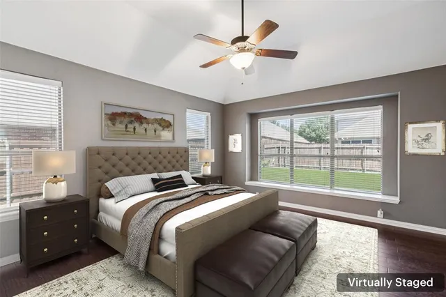 a bedroom with a large bed and a large window