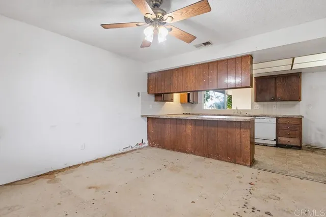 a kitchen with granite countertop wooden cabinets and a counter top space