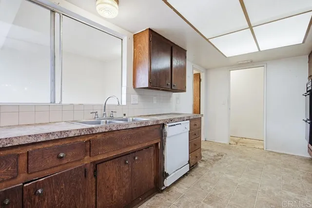 an empty room with a ceiling fan and a window