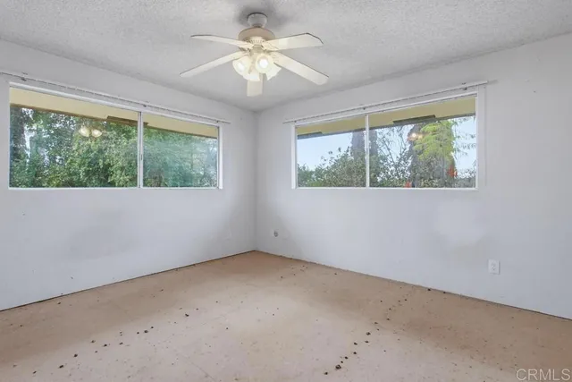 a spacious bathroom with a granite countertop sink a toilet and a mirror