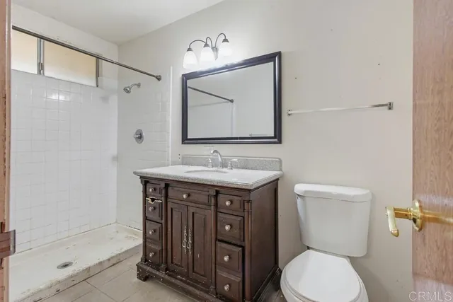 a view of a hallway with a washer dryer and chandelier