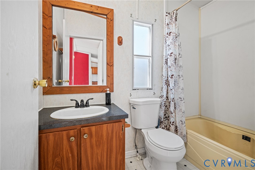 14306 Wilkinson Road Dewitt, VA 23840 - Photo 27 of 60 Vanity with wood-finish cabinetry, black counterto