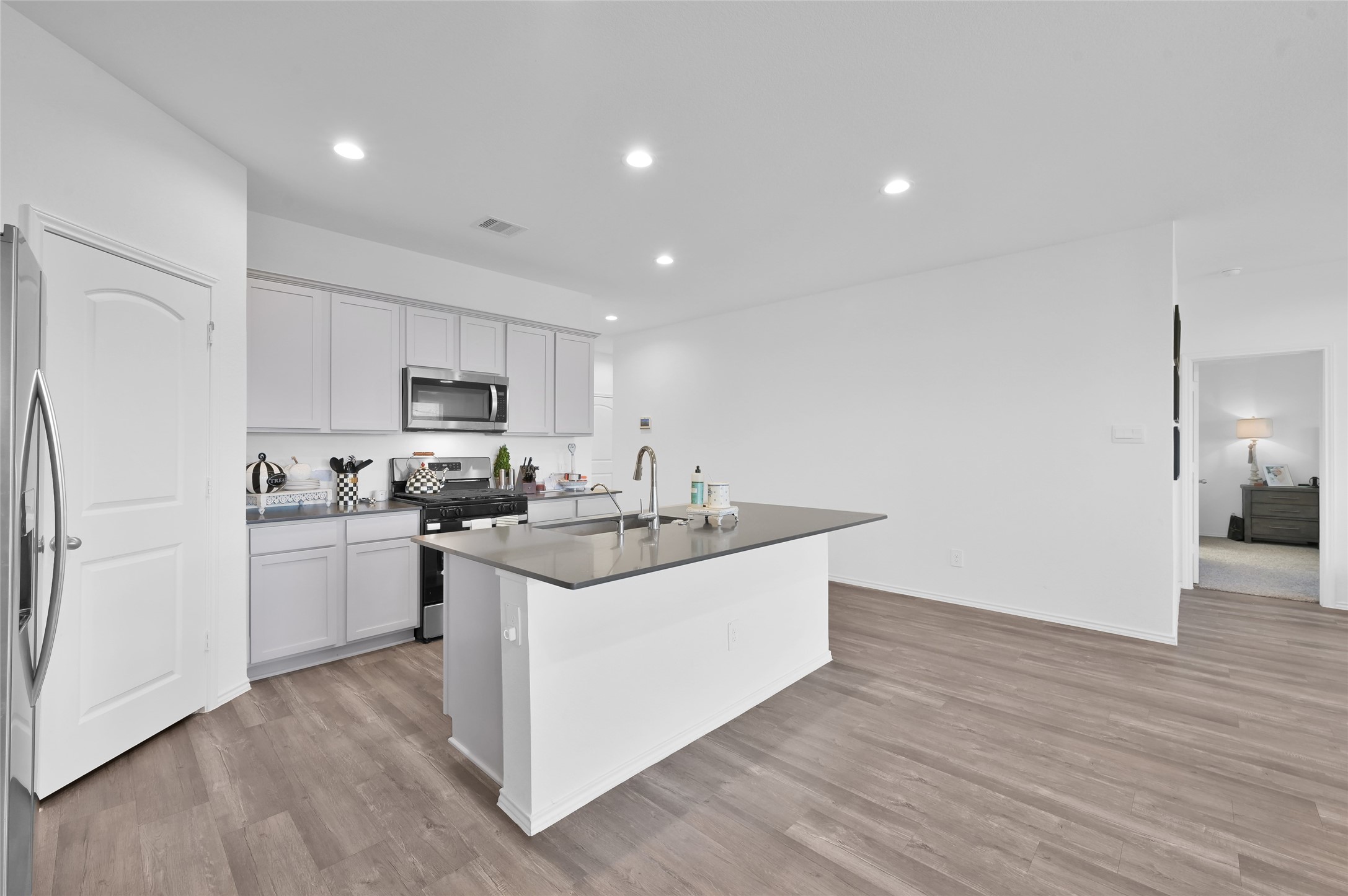 12369 Carib Crossing Lane Conroe, TX 77304 - Photo 12 of 43 a kitchen with sink stove and refrigerator