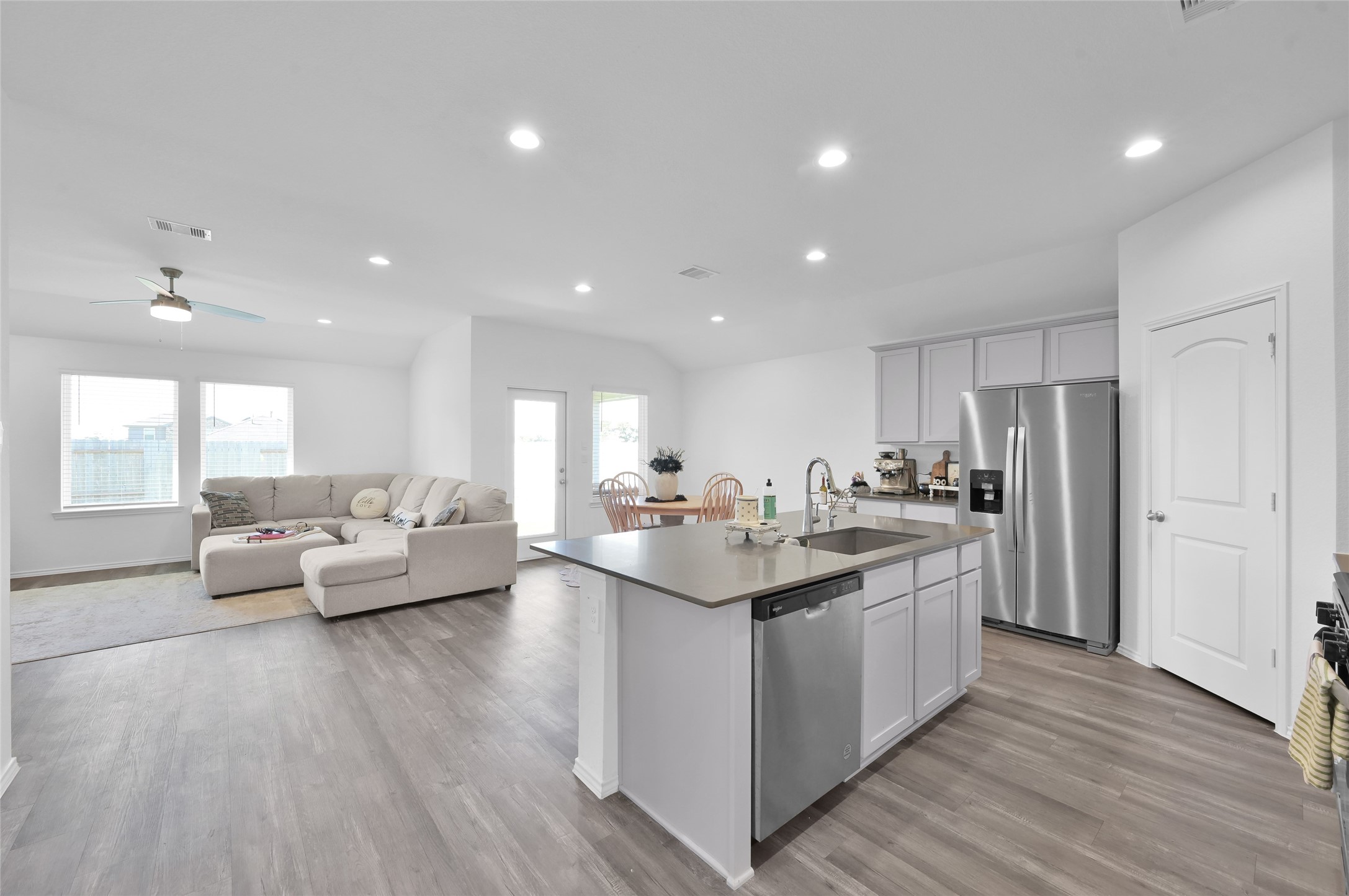 12369 Carib Crossing Lane Conroe, TX 77304 - Photo 14 of 43 a living room with stainless steel appliances kitchen island granite countertop a couch and wooden floor