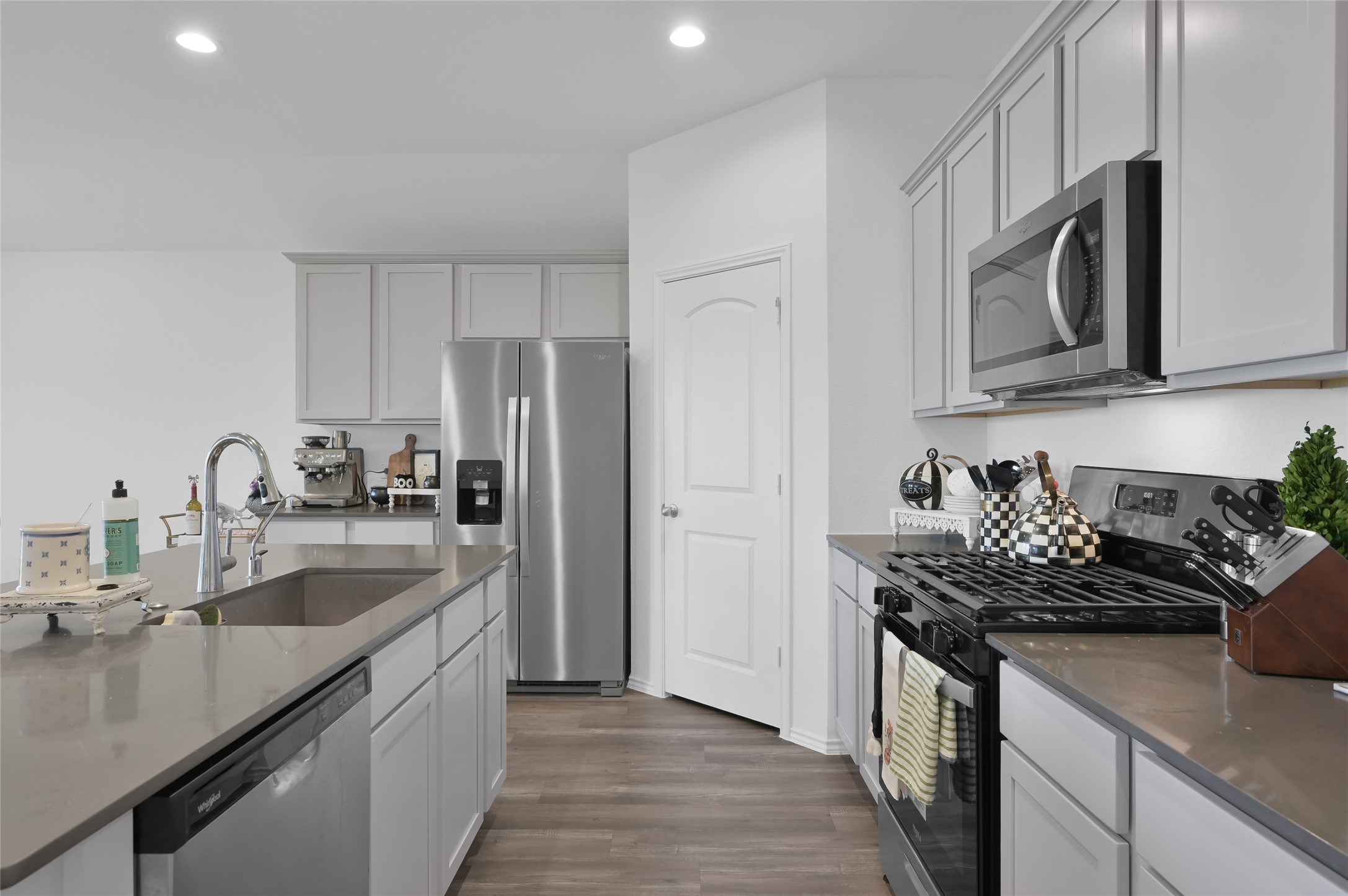12369 Carib Crossing Lane Conroe, TX 77304 - Photo 15 of 43 a kitchen with sink a stove and cabinets
