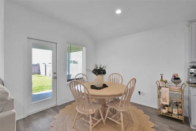 a view of a dining room with furniture and a window