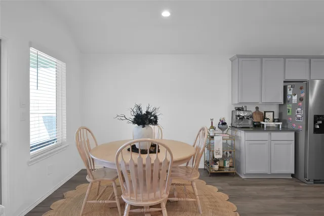 a view of a dining room with furniture and a window
