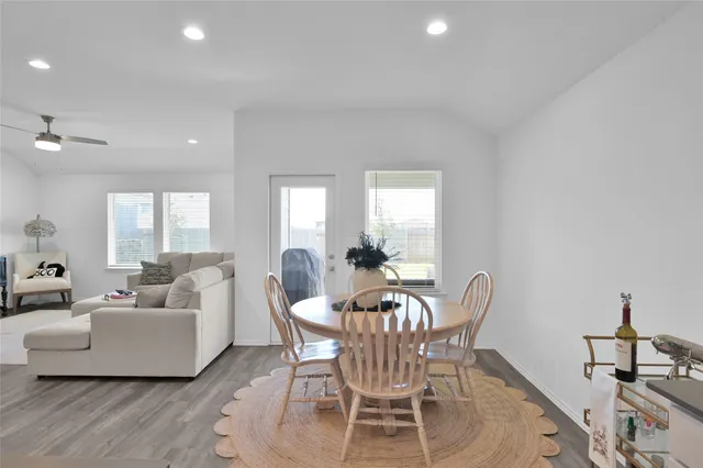 a dining room with furniture and wooden floor