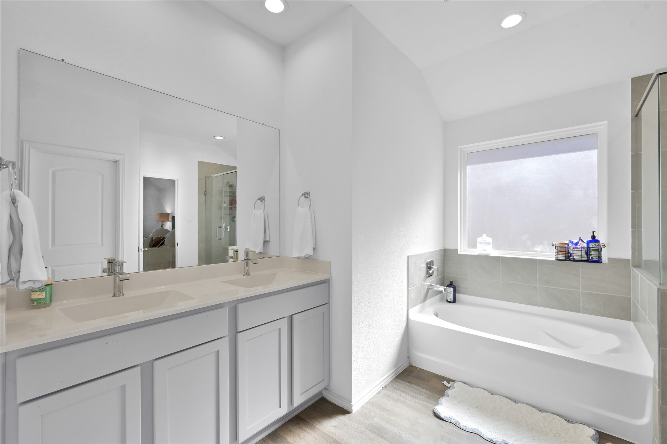 12369 Carib Crossing Lane Conroe, TX 77304 - Photo 24 of 43 a bathroom with a tub a sink and a mirror