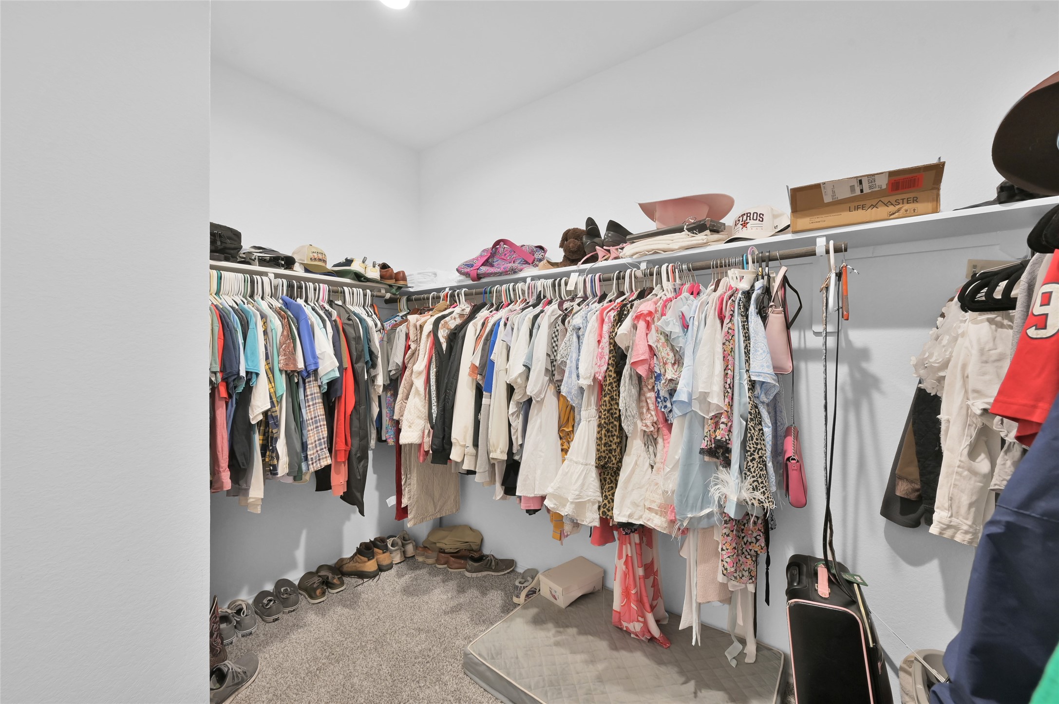 12369 Carib Crossing Lane Conroe, TX 77304 - Photo 25 of 43 a view of walk in closet with clothes