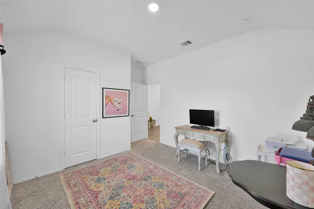 a view of a workspace with furniture and a flat screen tv