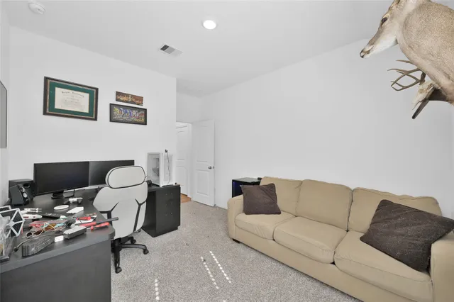 a living room with furniture a couch and a window