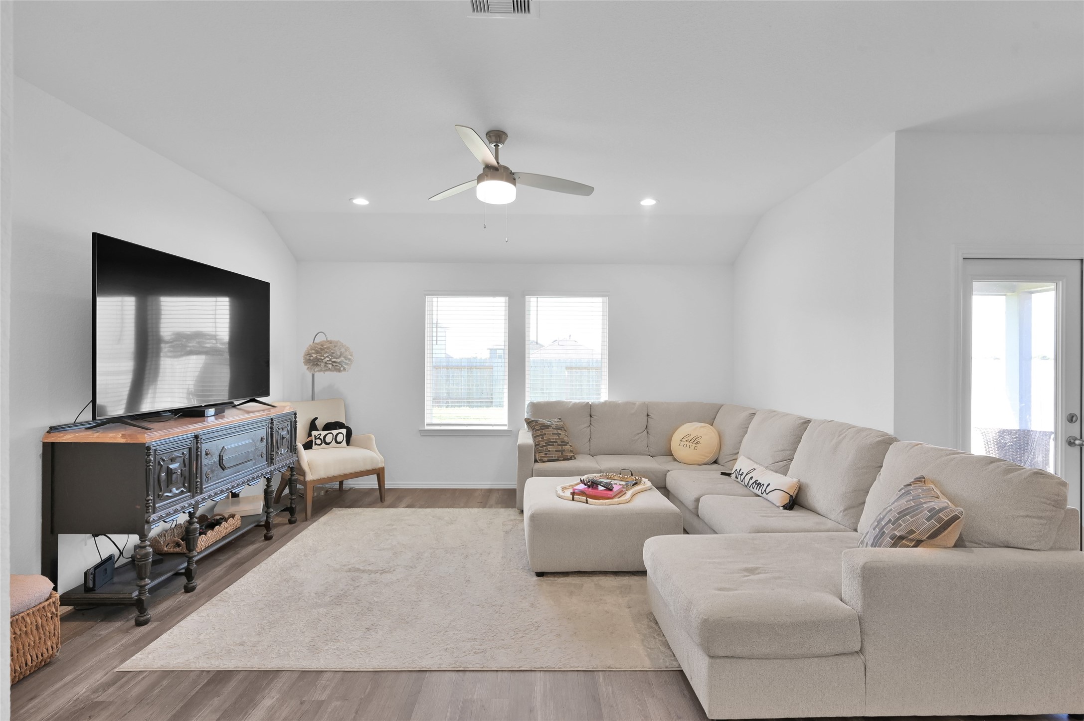 12369 Carib Crossing Lane Conroe, TX 77304 - Photo 7 of 43 a living room with furniture and a flat screen tv