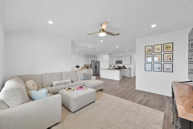 a living room with furniture and kitchen view
