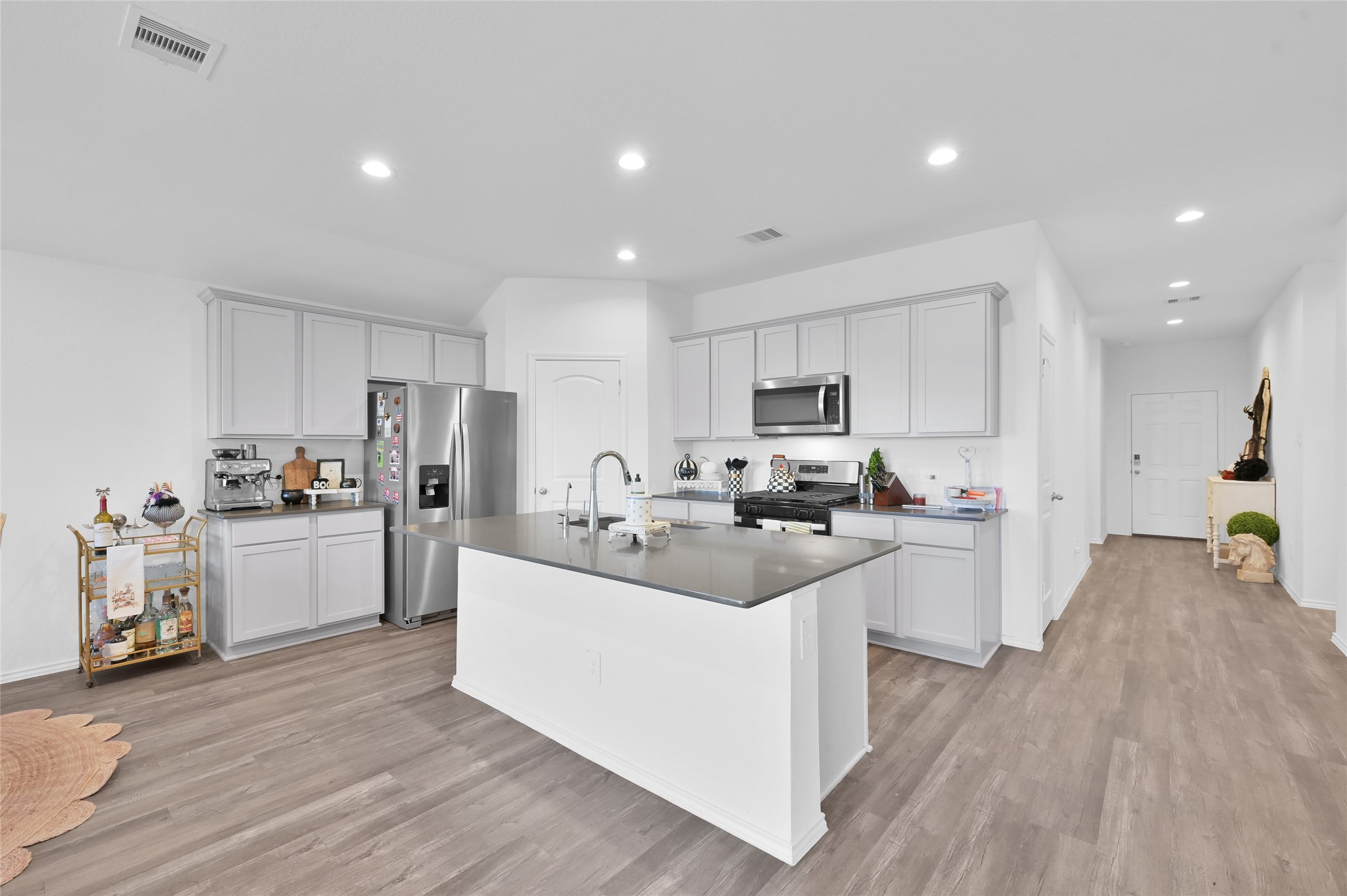 12369 Carib Crossing Lane Conroe, TX 77304 - Photo 10 of 43 a kitchen with refrigerator a sink and cabinets