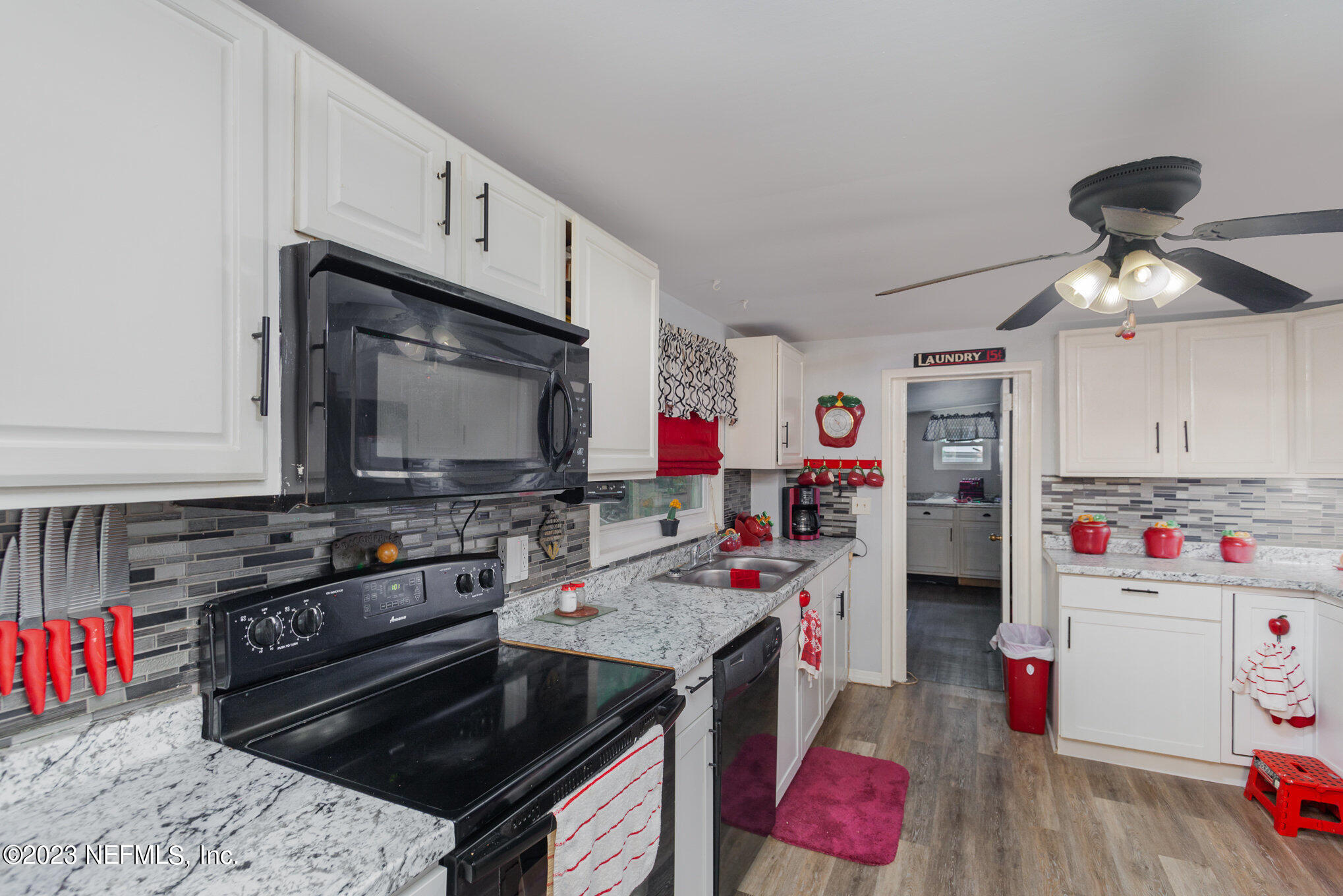 145 North Orange Street Starke, FL 32091 - Photo 11 of 26 a kitchen with a stove and a microwave