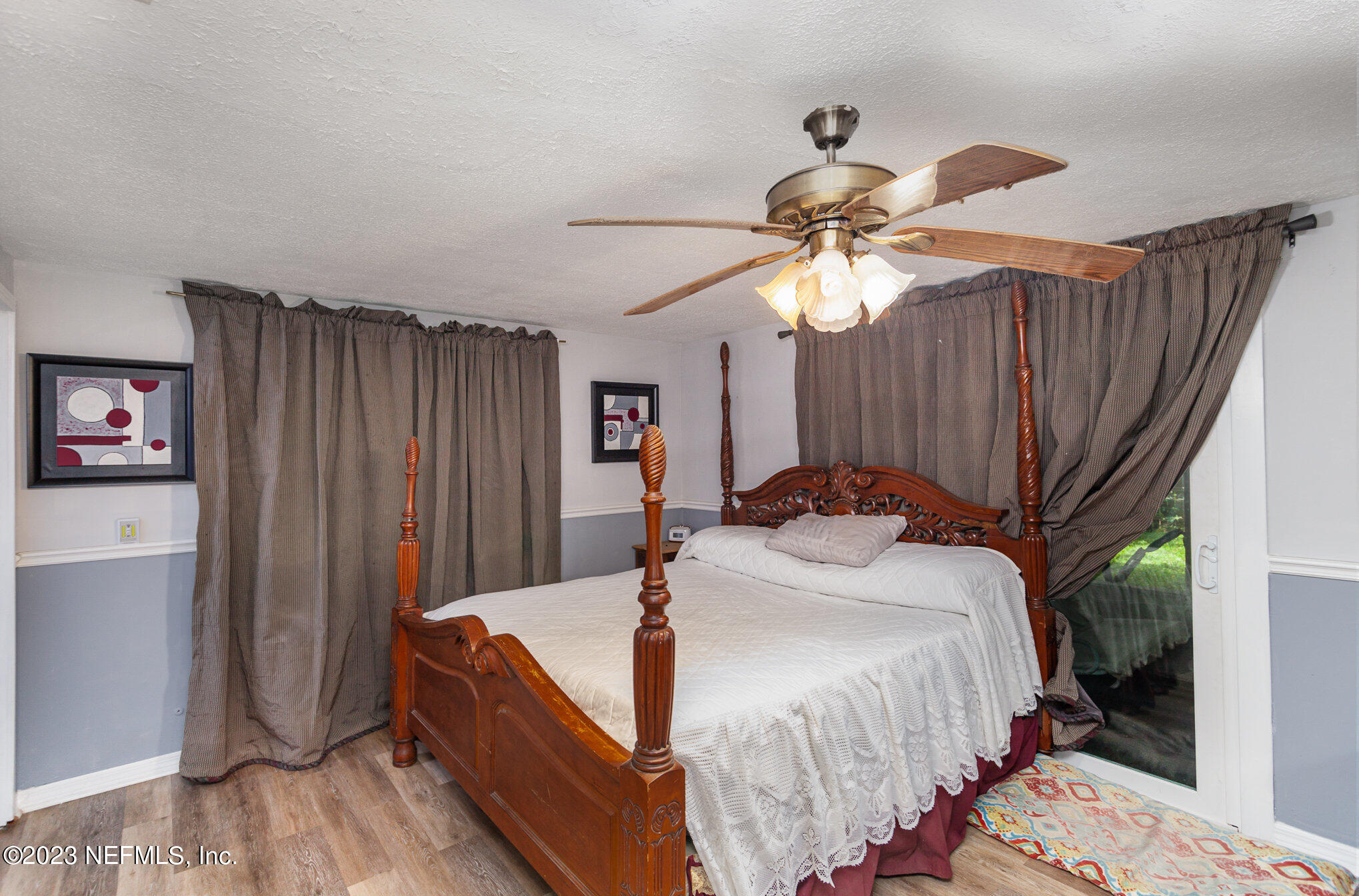 145 North Orange Street Starke, FL 32091 - Photo 15 of 26 a bedroom with a bed and a chandelier