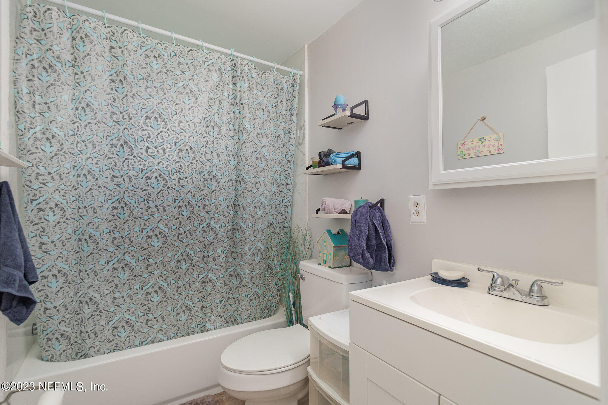145 North Orange Street Starke, FL 32091 - Photo 17 of 26 a bathroom with a toilet and a shower curtain