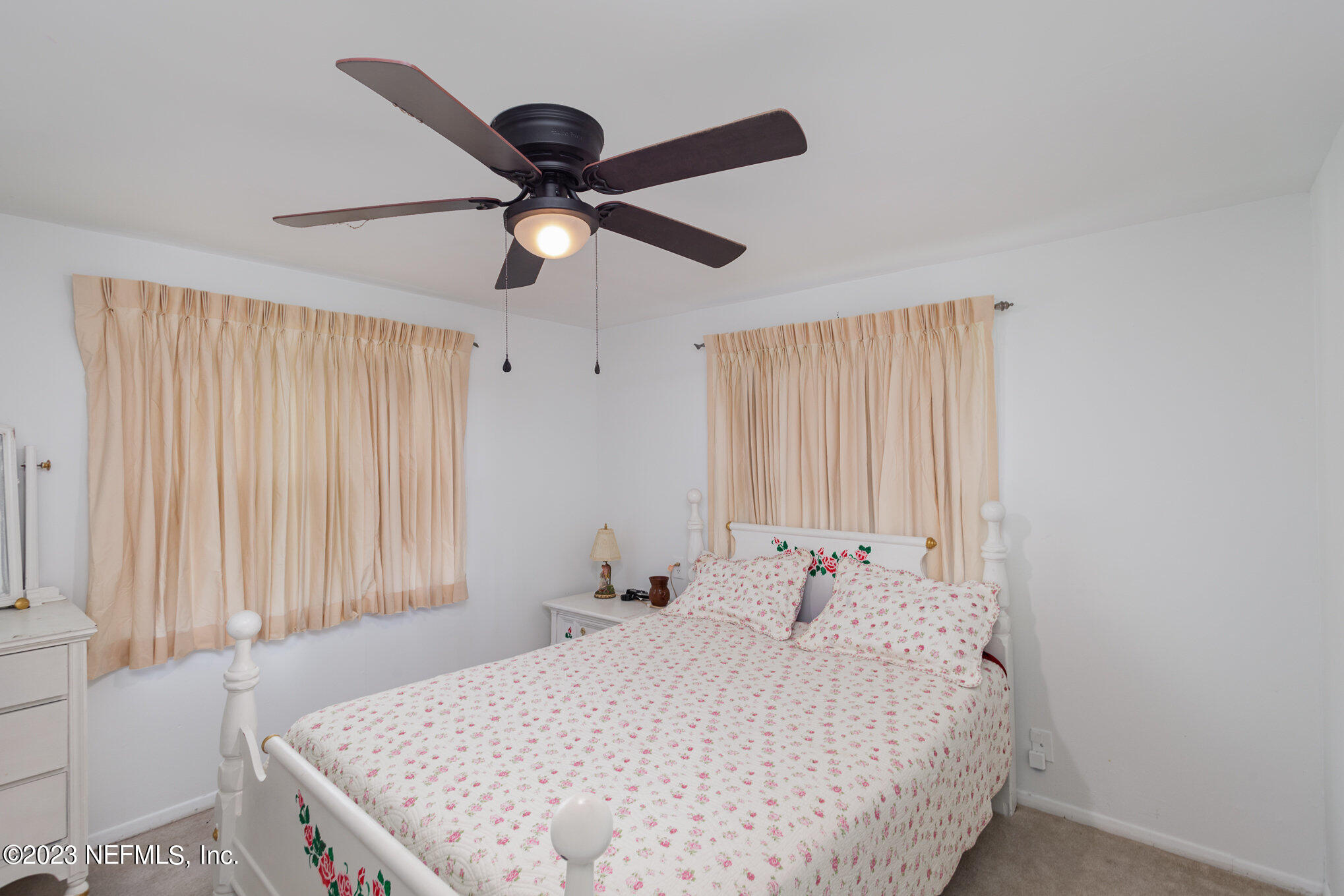 145 North Orange Street Starke, FL 32091 - Photo 18 of 26 a bedroom with a bed and a chandelier