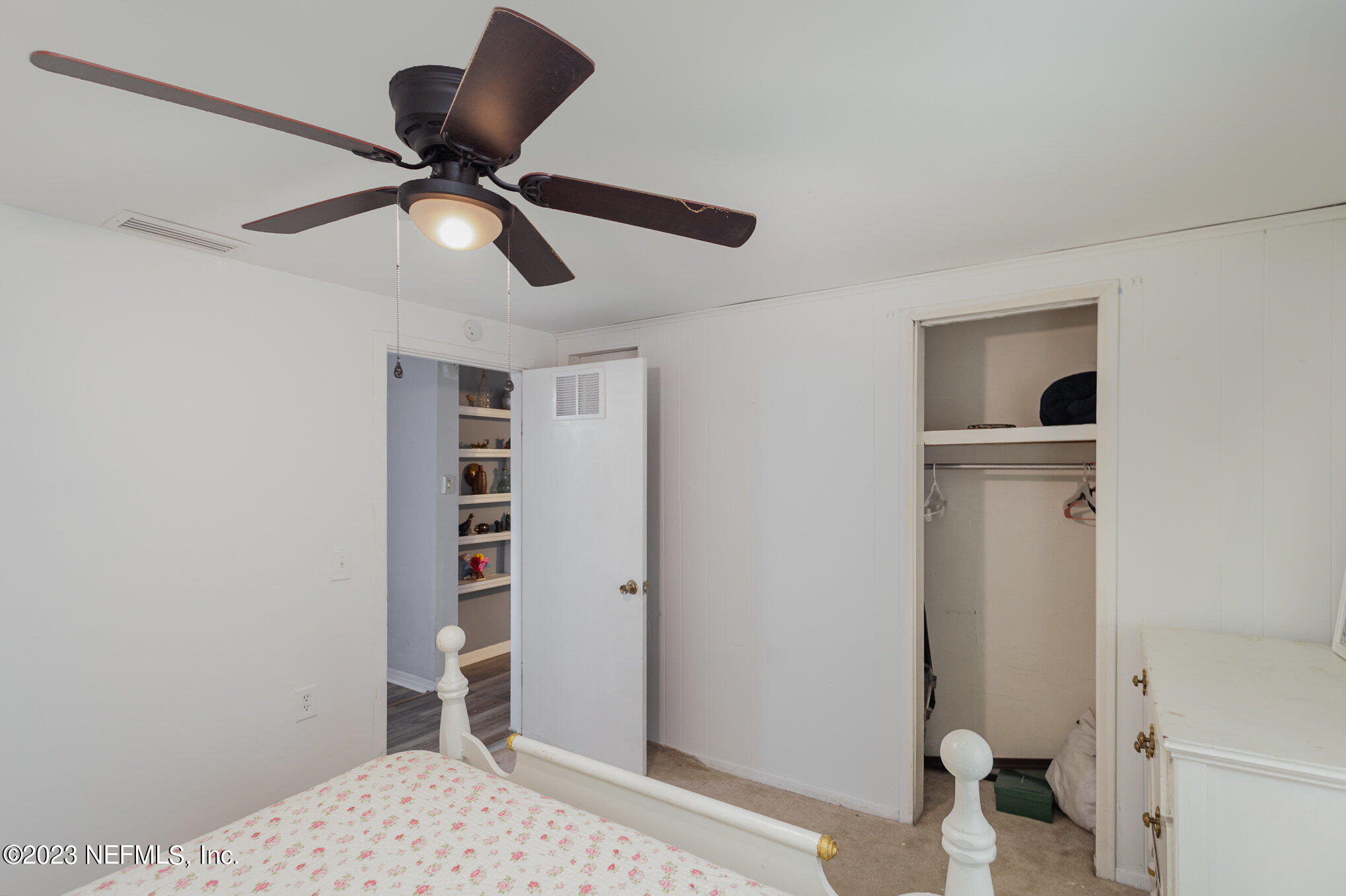 145 North Orange Street Starke, FL 32091 - Photo 19 of 26 a view of a bedroom with a bed and cabinets
