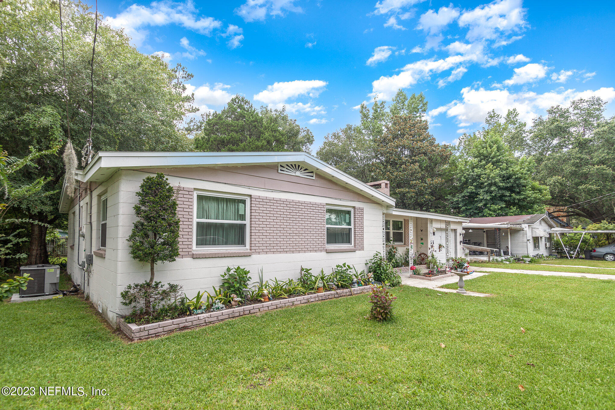 145 North Orange Street Starke, FL 32091 - Photo 2 of 26 a view of a house with backyard sitting area and garden