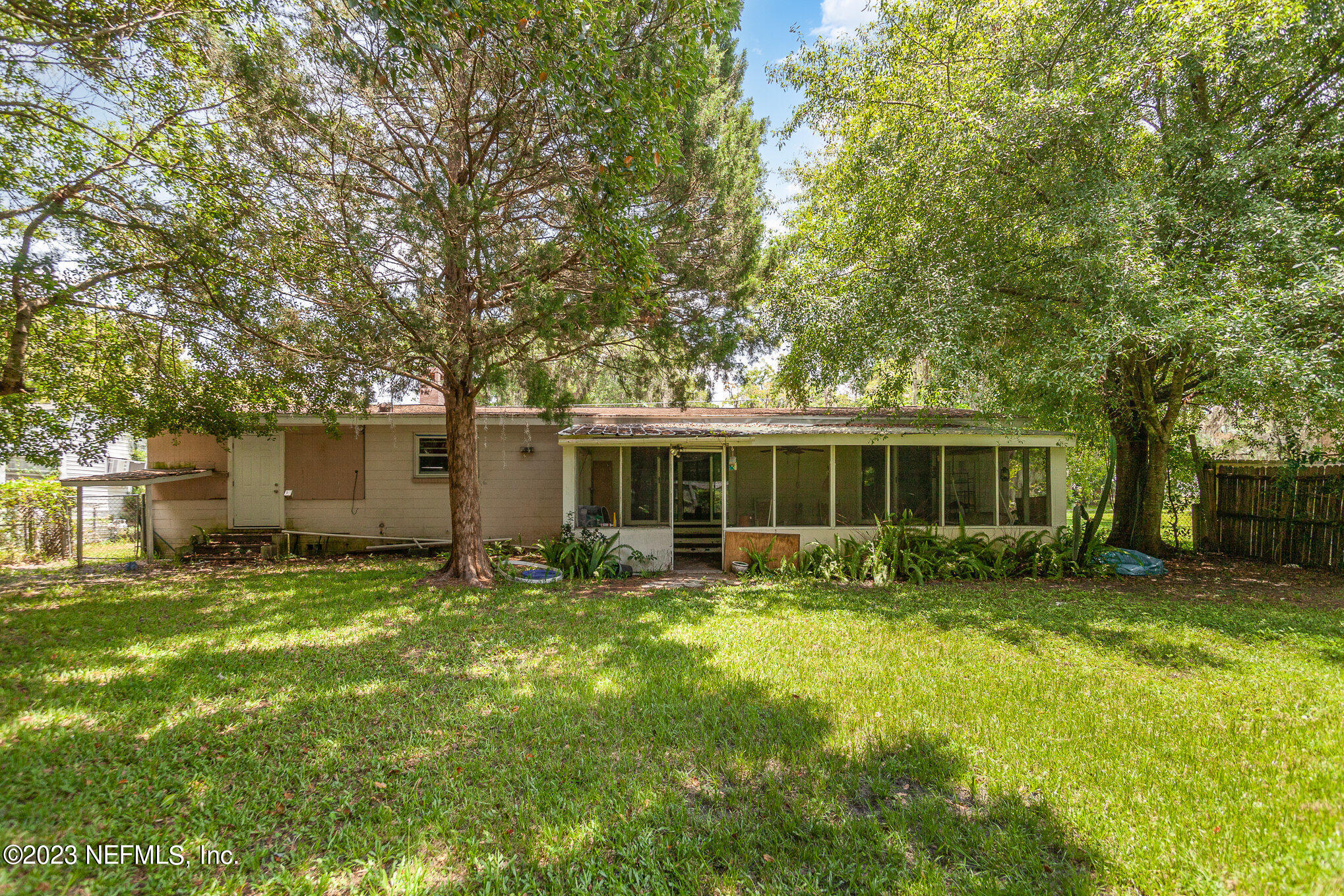 145 North Orange Street Starke, FL 32091 - Photo 23 of 26 a backyard of a house with yard and outdoor seating
