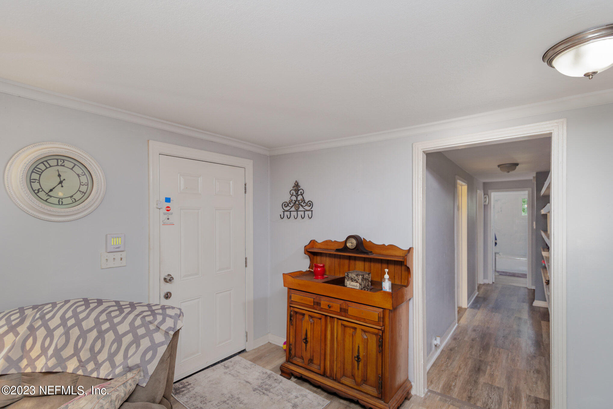 145 North Orange Street Starke, FL 32091 - Photo 4 of 26 a bedroom with a bed and a chandelier