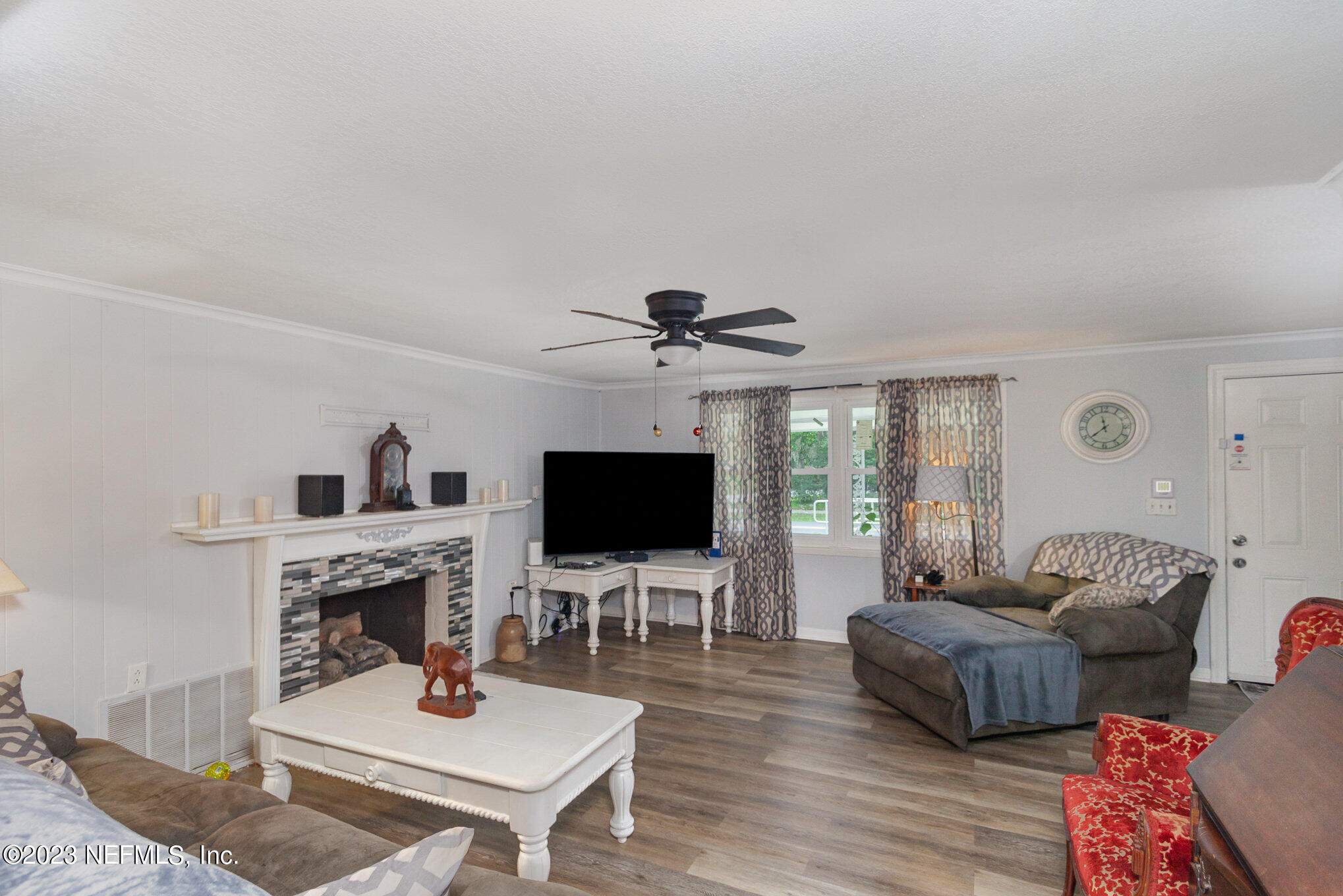 145 North Orange Street Starke, FL 32091 - Photo 5 of 26 a living room with furniture a fireplace and a flat screen tv
