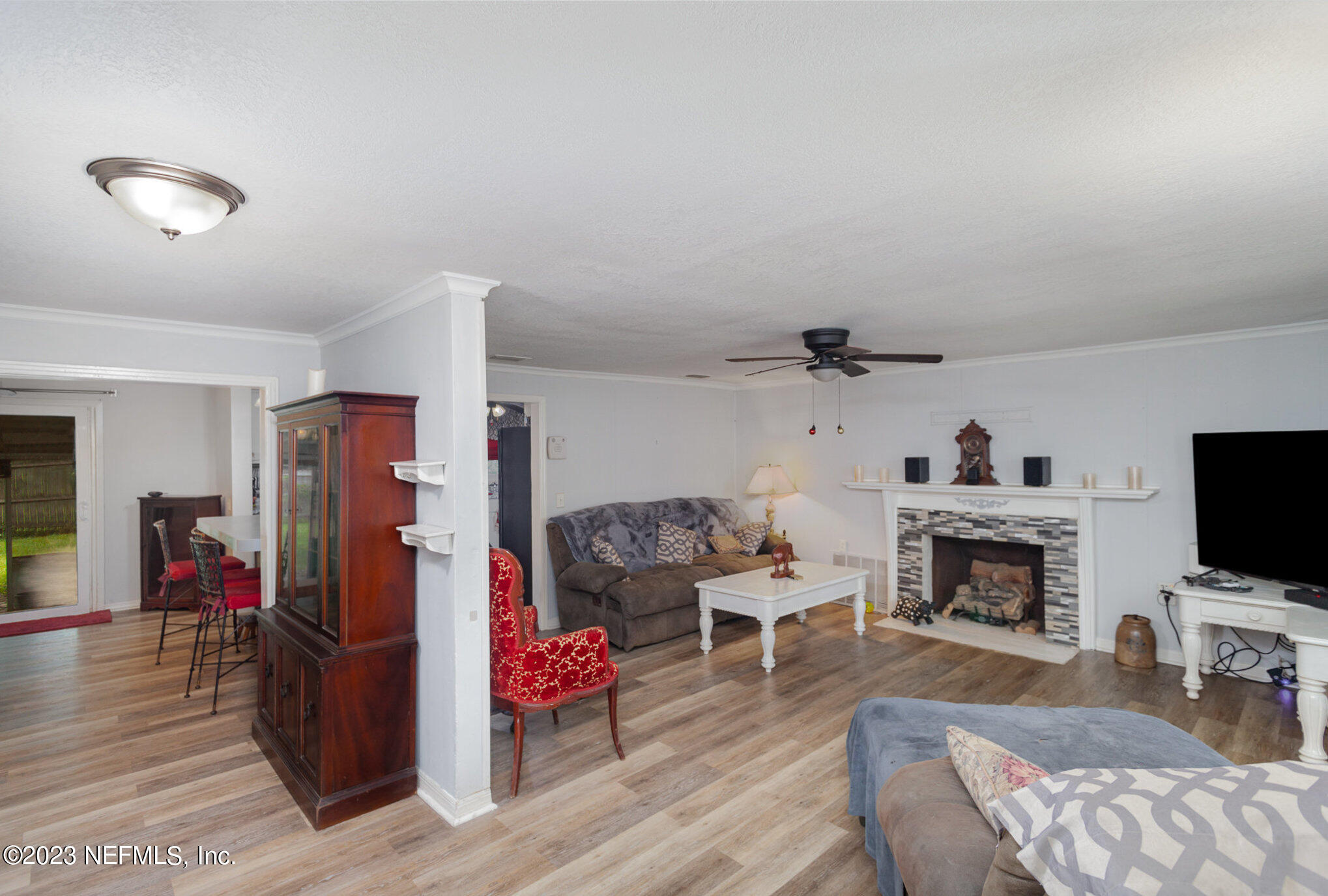 145 North Orange Street Starke, FL 32091 - Photo 6 of 26 a living room with furniture and a flat screen tv